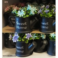 Mini flowering plant in a smiling can 12*11 cm Mini flowering plant in a smiling can 12*11 cm